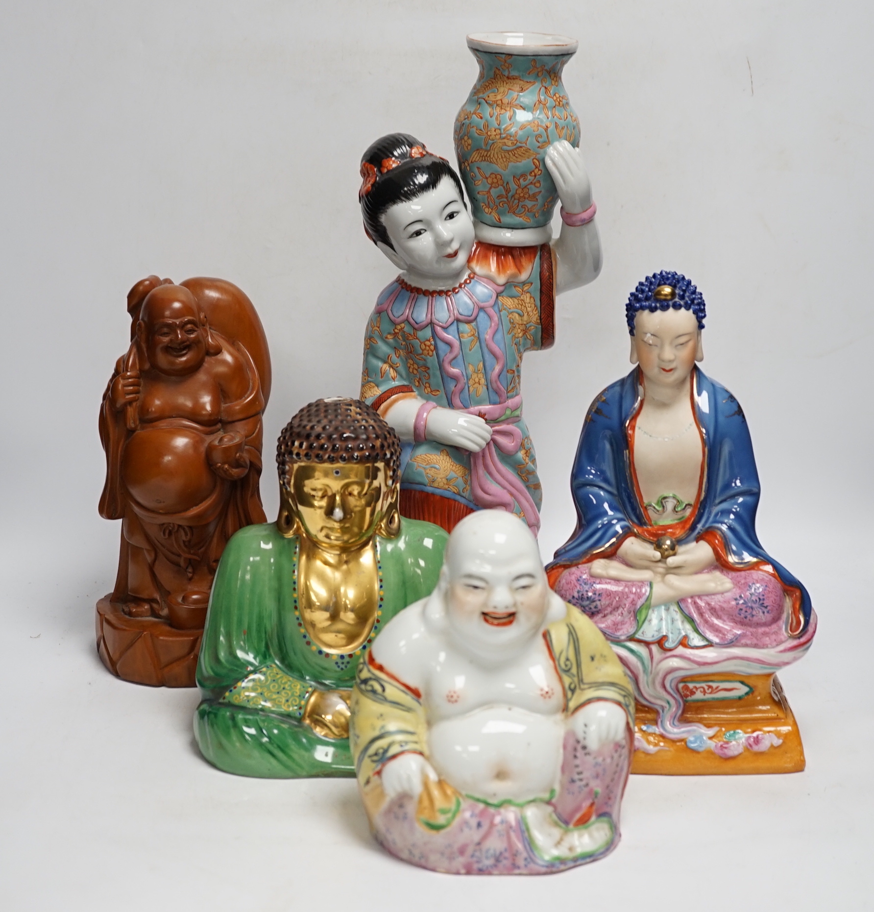 Five Chinese figures of Buddha or Budai, including a hardwood example, largest 38cm high